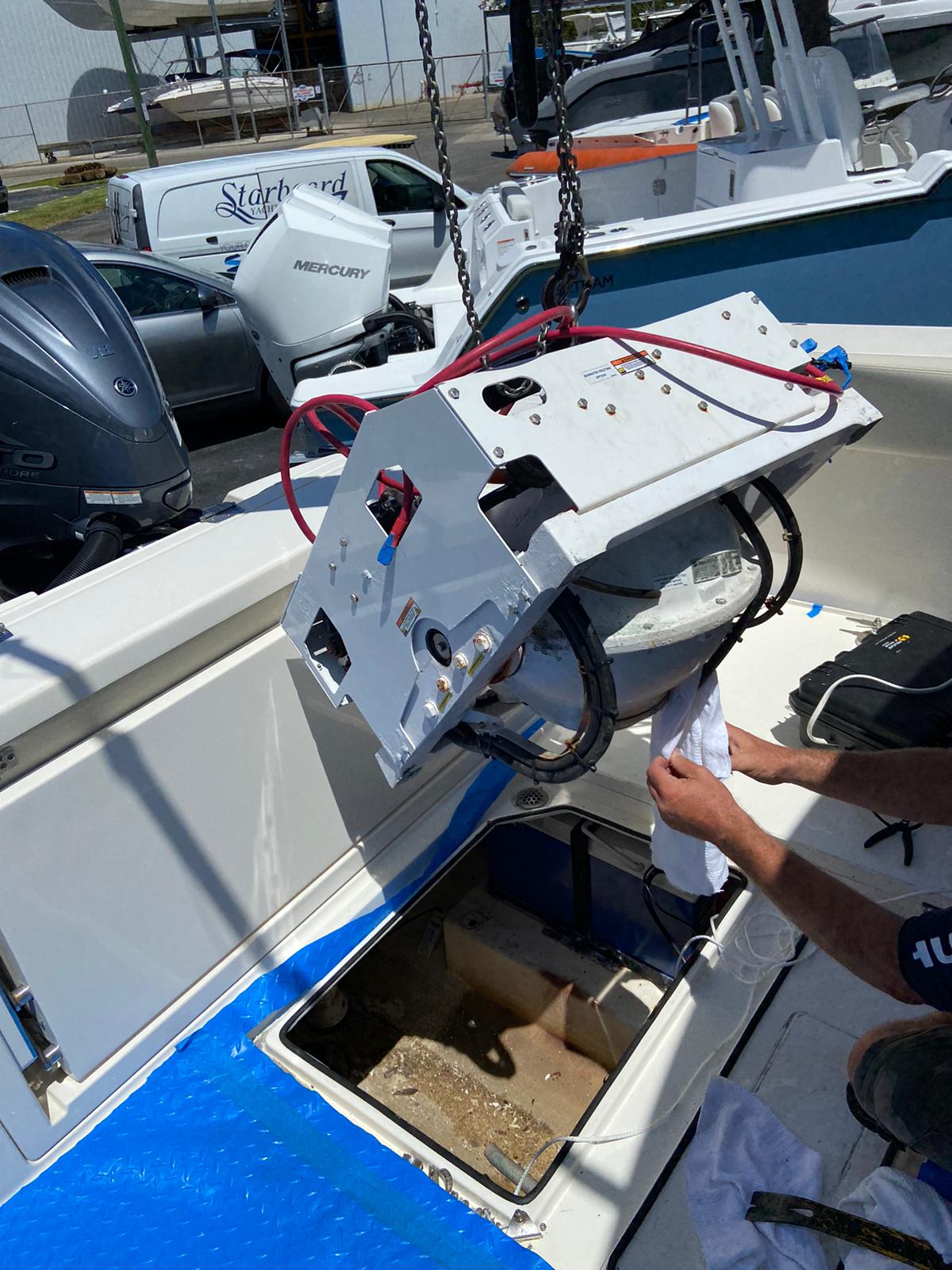 Seakeeper SK2 unit being crane-removed from Cobia 33 DC at Starboard Yacht Group — less than 21 months old, warranty claim denied